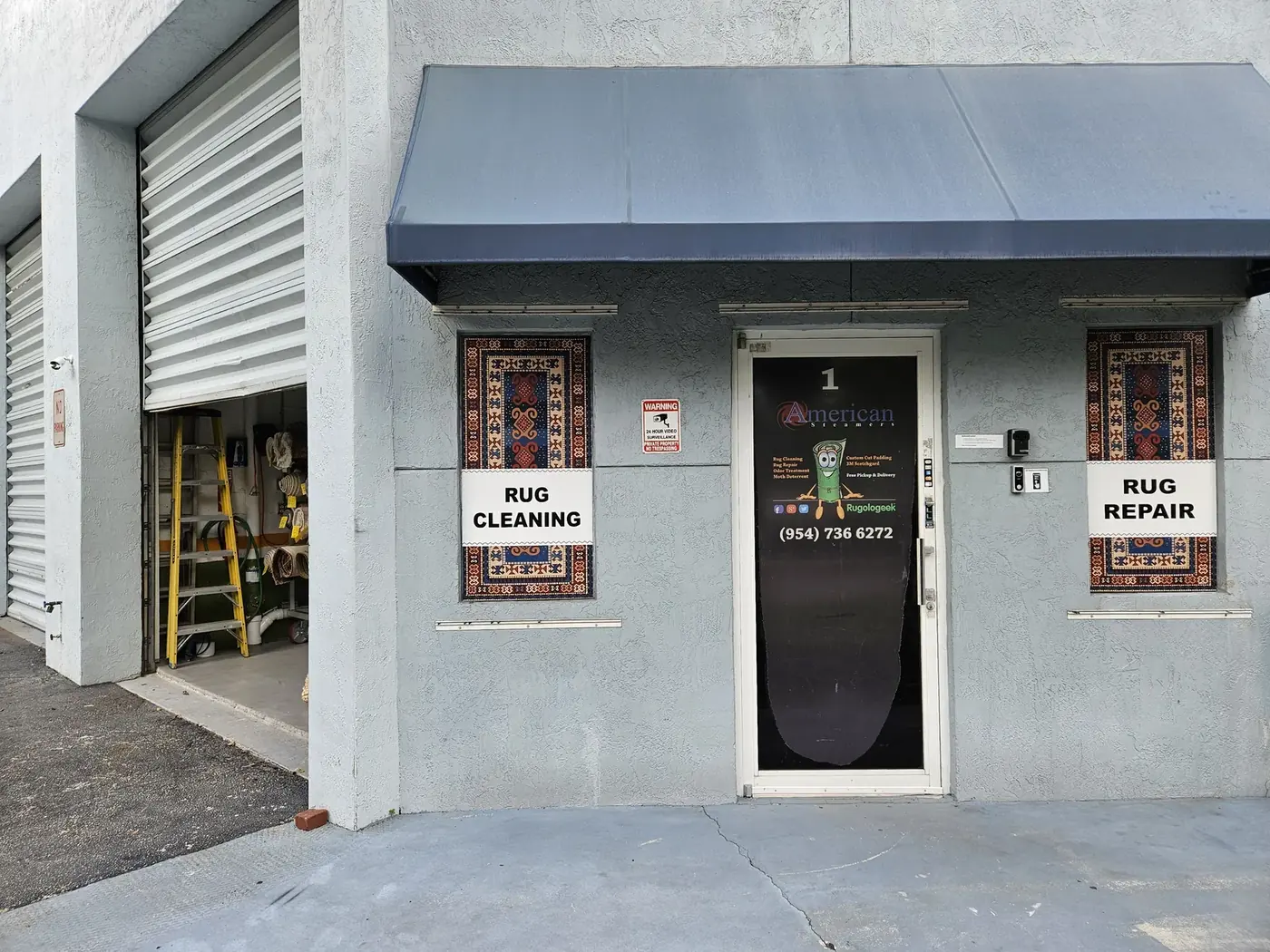 Plant entrance with rug cleaning and rug repair signage
