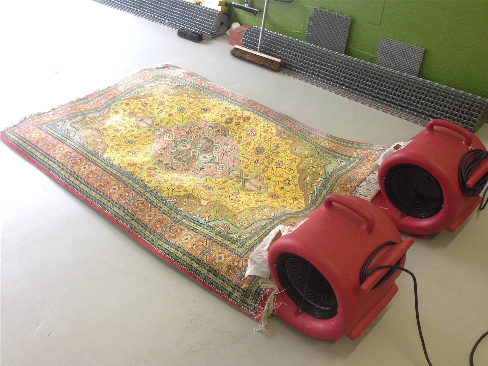 Fine silk rug drying flat with air movers